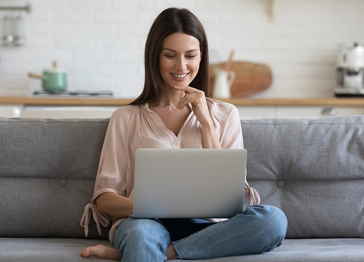 Smiling lady look into laptop