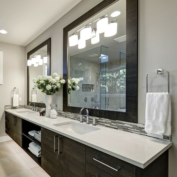 Spacious bathroom in gray tones wizth long vanity